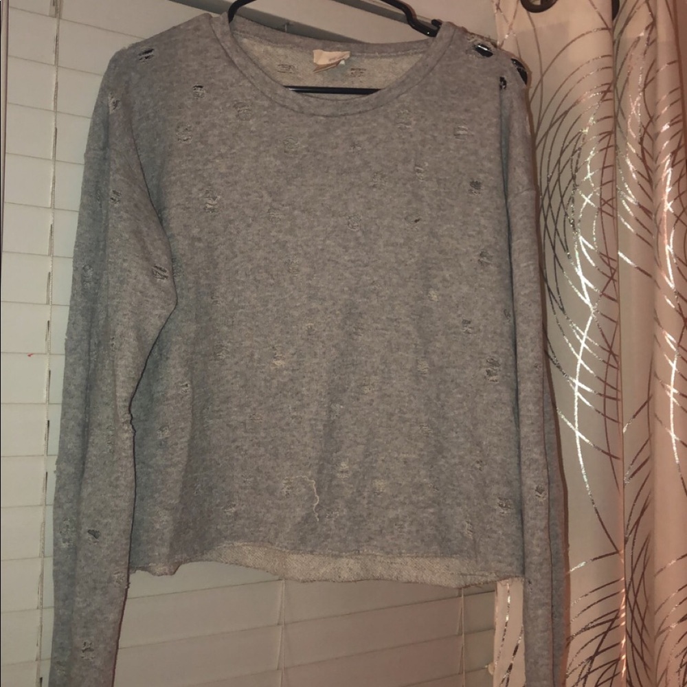 A grey holey t-shirt from wet seal! Size: M